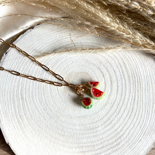 Necklace with watermelon pendant on a white surface